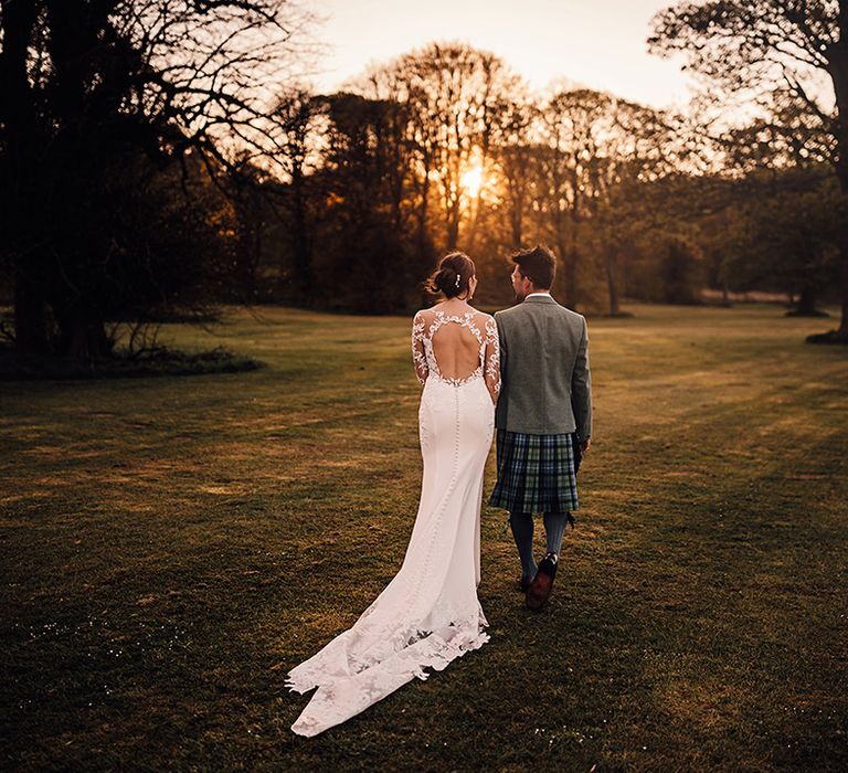 golden-hour-couple-portrait-with-bride-in-cutout-back-wedding-dress