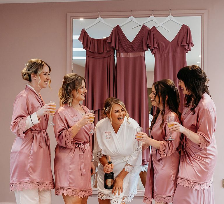 bridal-party-in-pink-satin-robes-getting-ready