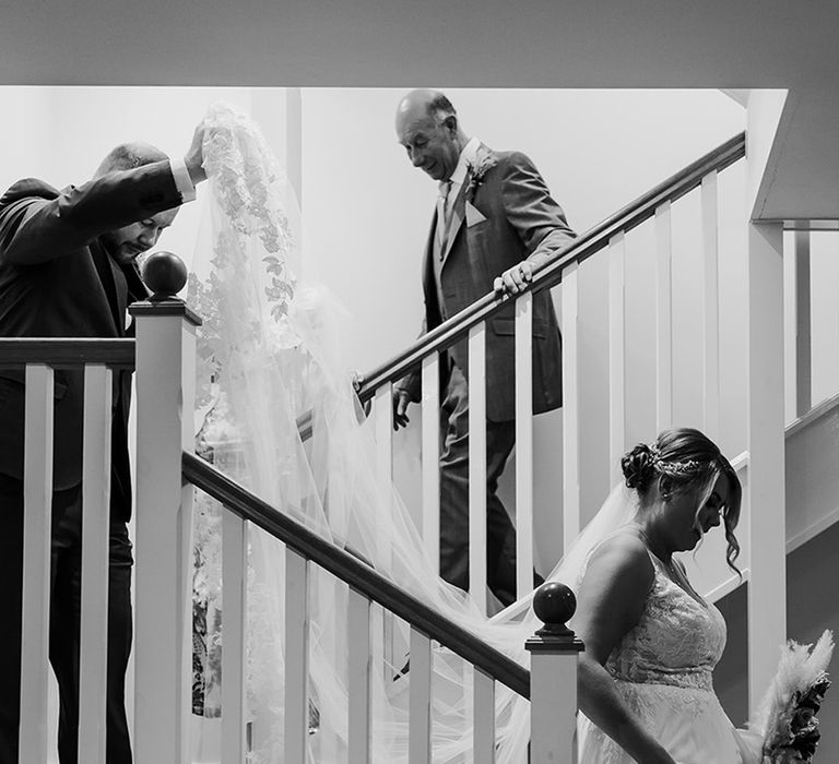 father-of-the-bride-helps-bride-down-the-stairs