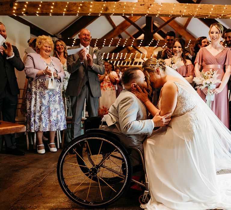 groom-in-wheelchair-with-bride-at-their-interabled-wedding-ceremony