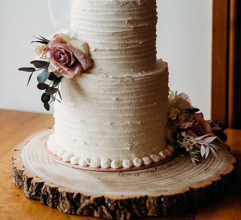 two-tier-wedding-cake-with-pink-roses-with-bespoke-bride-and-groom-cake-toppers