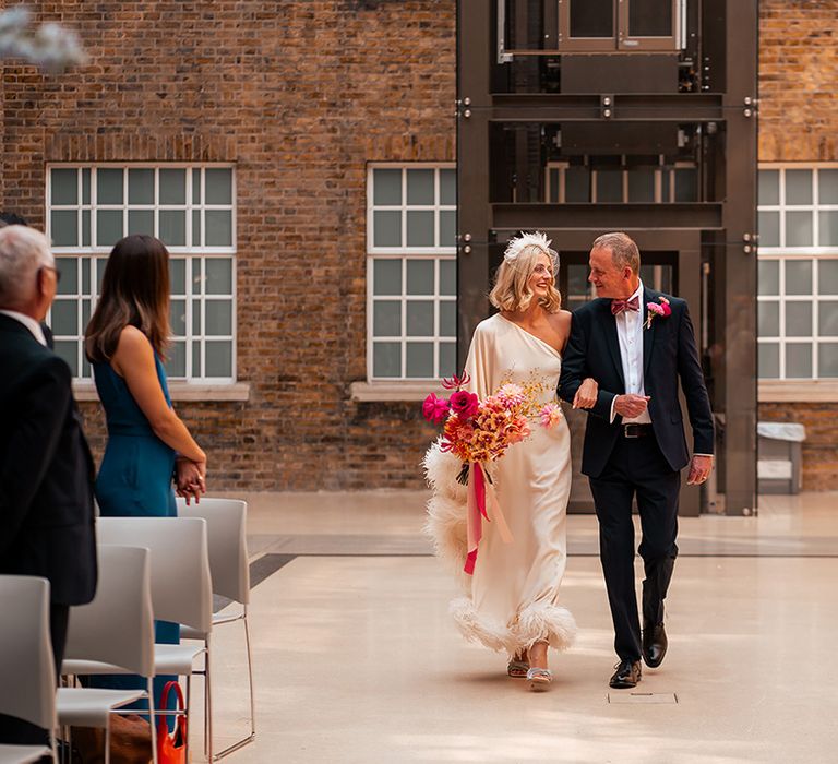 bride-walks-down-the-aisle-with-father-of-the-bride