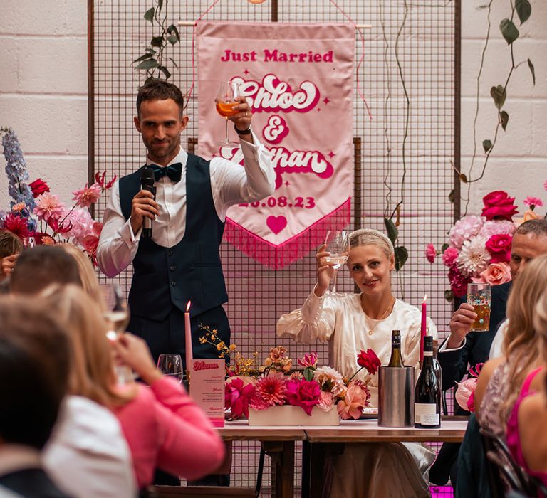 groom-reads-wedding-speech-while-bride-laughs