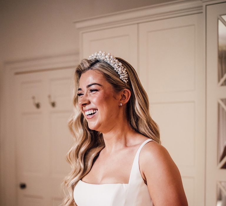 bride-in-suzanne-neville-wedding-dress-with-pearl-wedding-headband