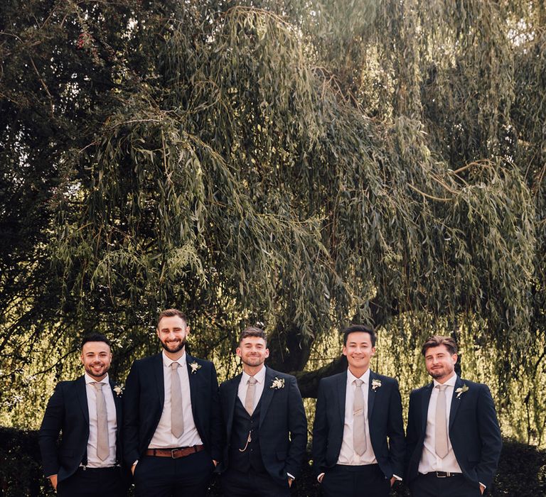 groom-and-groomsmen-in-matching-wedding-suits