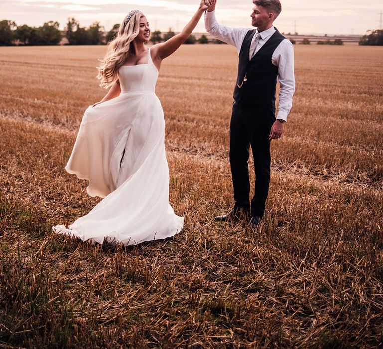 groom-spins-bride-around-for-wedding-photos