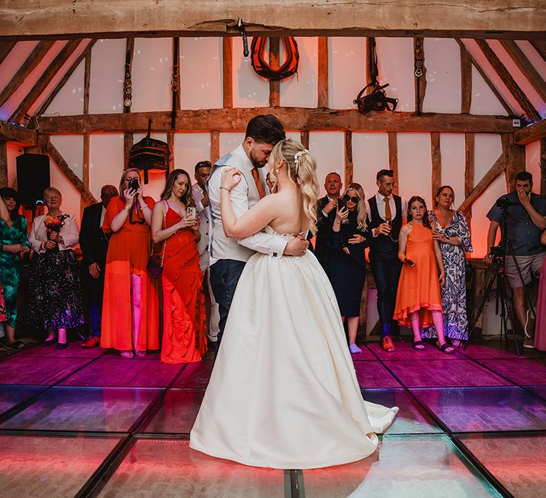 bride-and-groom-dancing-on-colourful-lights-dance-floor