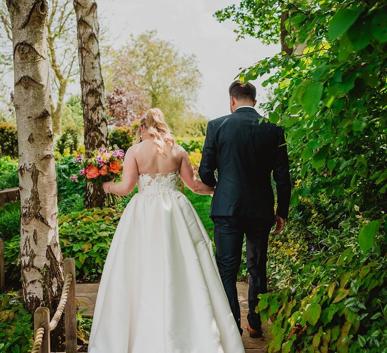 bride-in-strapless-wedding-dress-with-groom-in-navy-wedding-suit