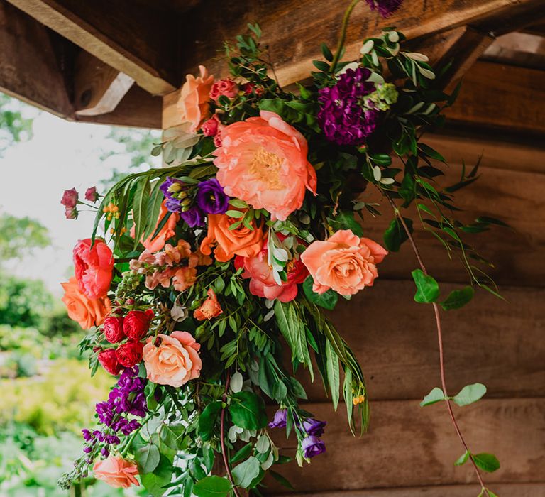 colourful-orange-and-purple-wedding-flower-arrangements