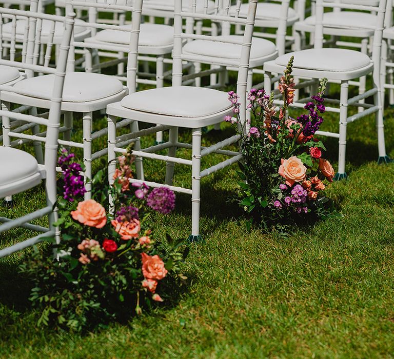 colourful-peach-and-purple-wedding-flower-aisle-arrangements