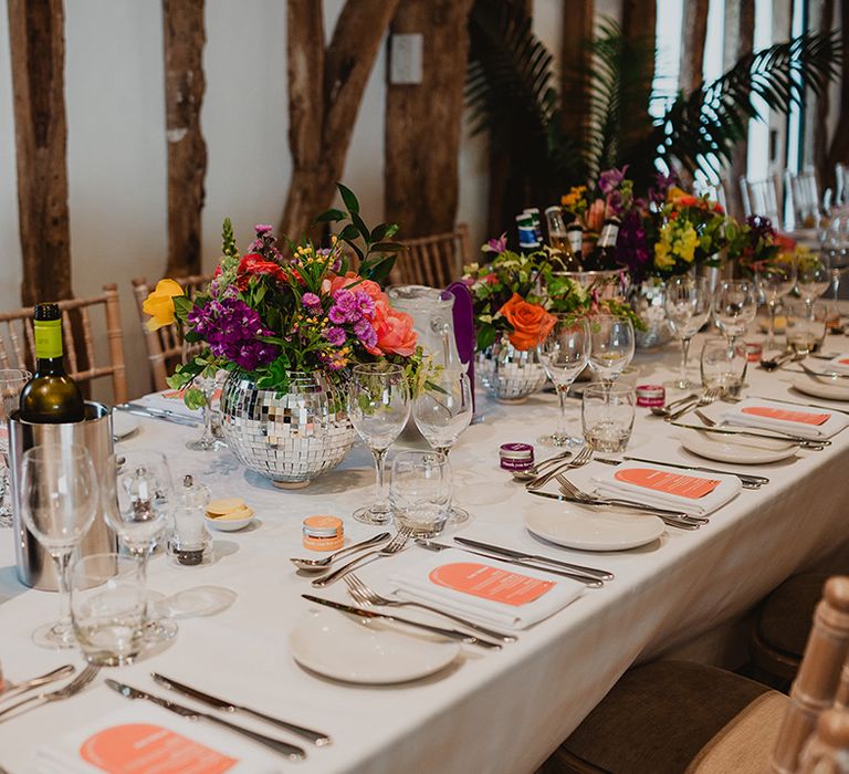 disco-ball-vase-wedding-table-centrepiece-with-peach-place-setting-and-stationery