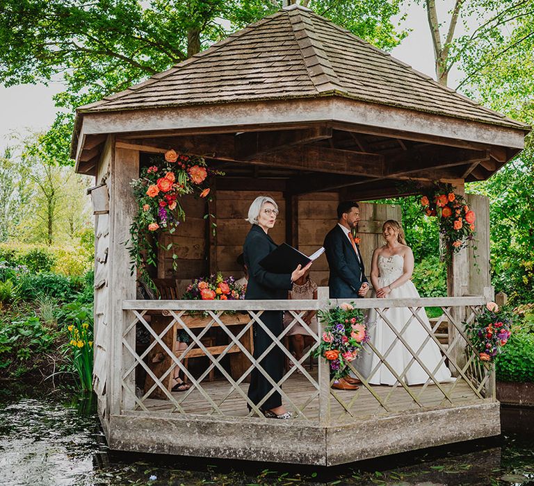 outdoor-gazebo-wedding-with-colourful-wedding-flowers