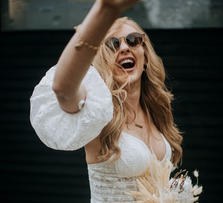 bride-in-boho-lace-wedding-dress-with-dried-flower-bouquet