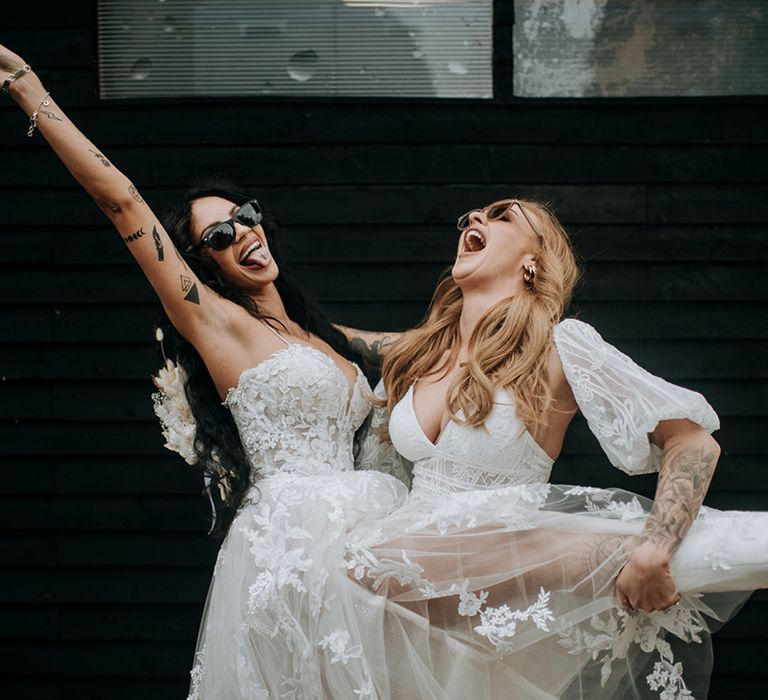 bride-in-floral-lace-wedding-dress-posing-with-bride-for-lgbtqi-wedding