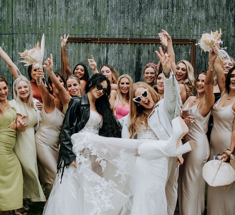 brides-celebrating-with-bridesmaids-in-satin-dresses-with-leather-jackets-and-sunglasses