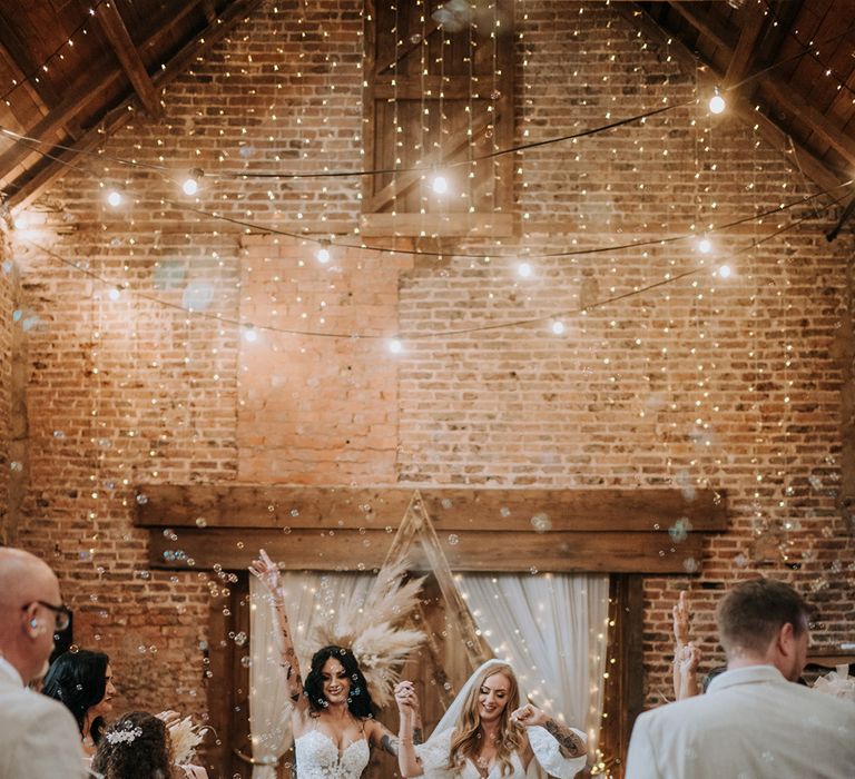 rustic-barn-wedding-with-fairy-lights-with-brides-at-boho-wedding