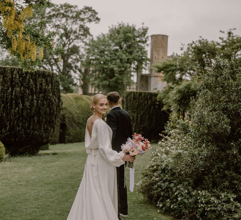 bride-and-groom-walking-around-castle-grounds