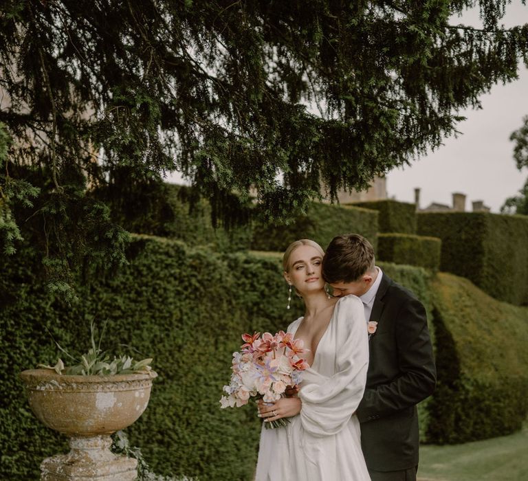 bride-wearing-puff-sleeve-dress-with-groom-in-black-suit