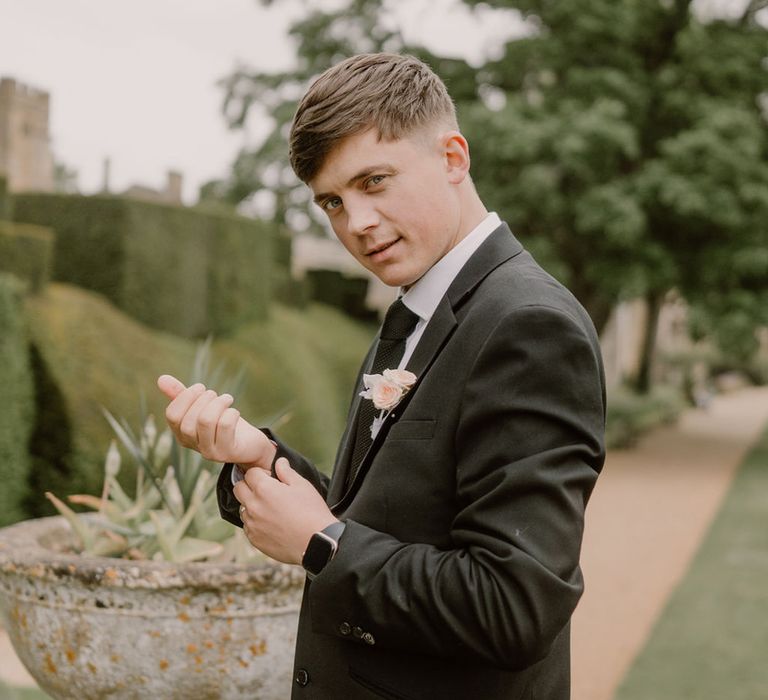 groom-in-black-wedding-suit-with-rose-buttonhole