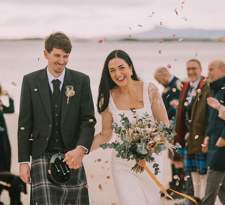 bride-and-groom-holding-hands-at-beach-wedding