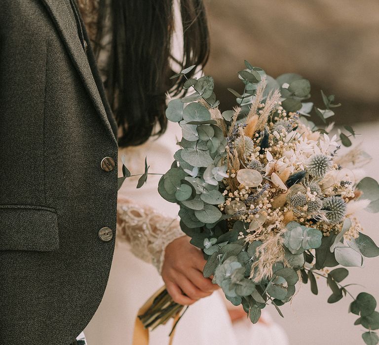 bride-holding-dried-flower-wedding-bouquet