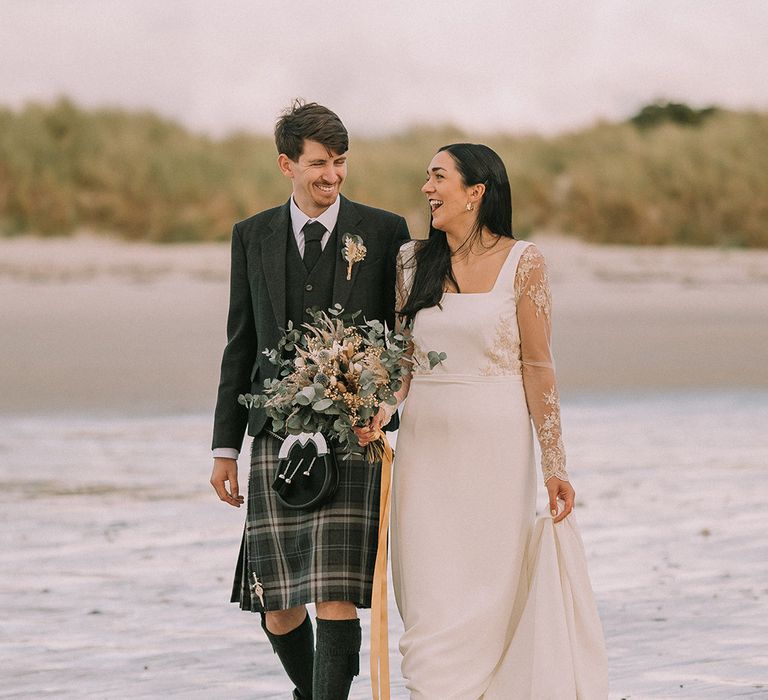 bride-in-lace-wedding-dress-with-groom-in-kilt