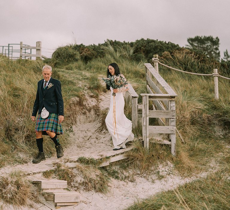 bride-walking-to-beach-ceremony