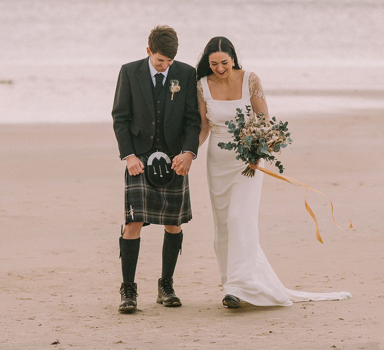 groom-in-kilt-with-bride-in-lace-wedding-dress