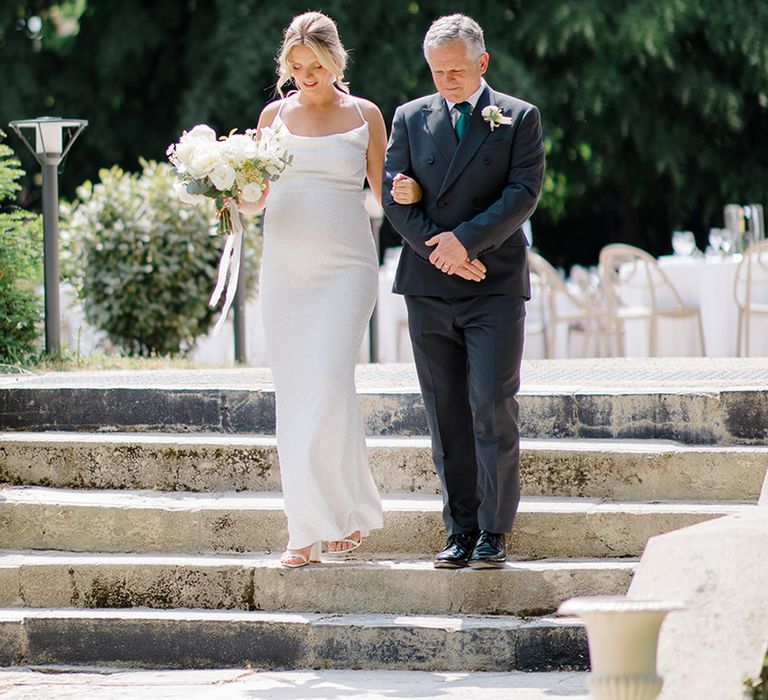 bride-in-maternity-wedding-dress-walking-with-father-of-the-bride