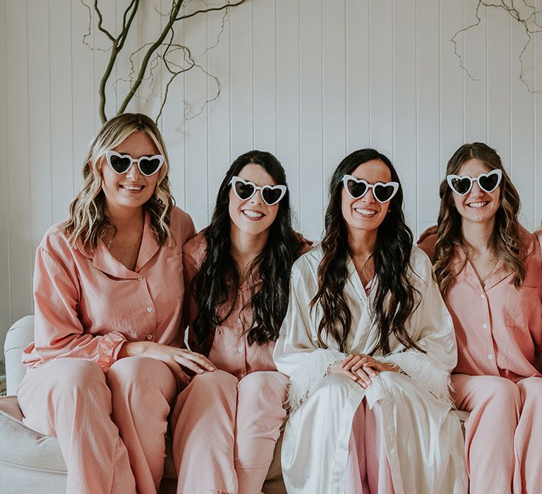 bridal-party-wearing-pink-pyjamas-with-heart-shaped-sunglasses