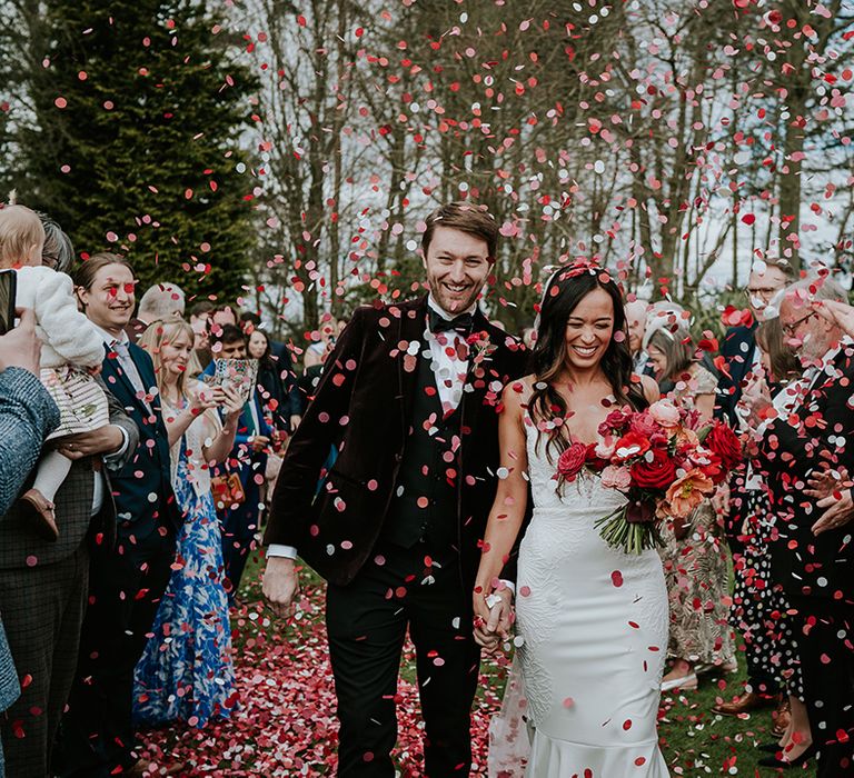 bride-and-groom-at-red-and-pink-confetti