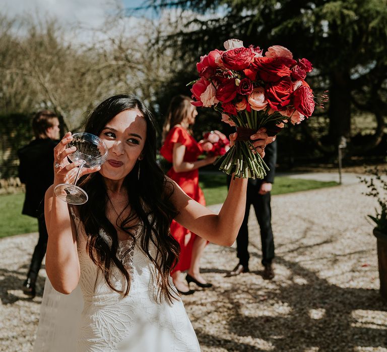 bride-holding-pink-and-red-bouquet