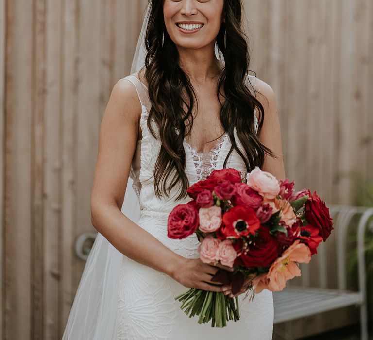 bride-wearing-flower-wedding-dress-with-pink-bouquet