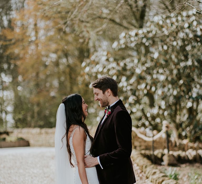 groom-in-velvet-suit-with-bride-gazing-into-his-eyes