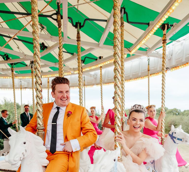 bride-and-groom-riding-on-carousel