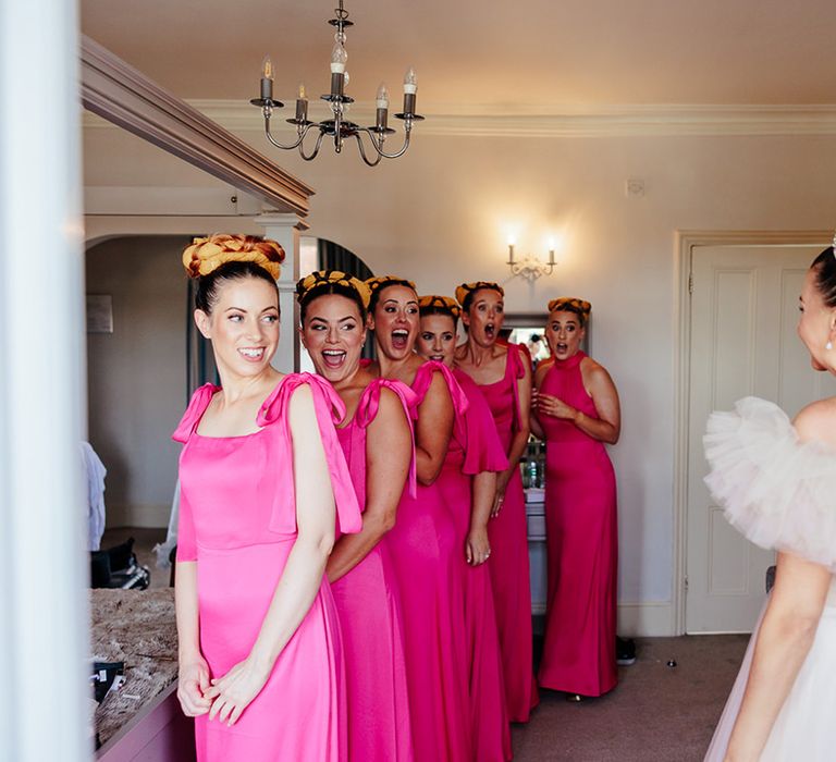 bridesmaids-wearing-pink-dresses-with-bride-in-pink-wedding-dress-and-crown