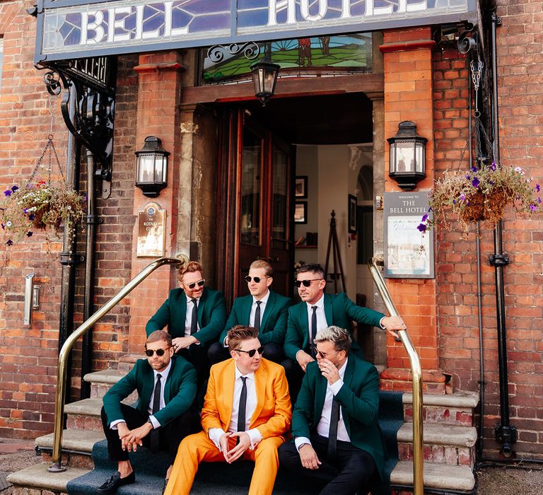 groomsmen-in-green-suits-with-groom-in-mustard-wedding-suit