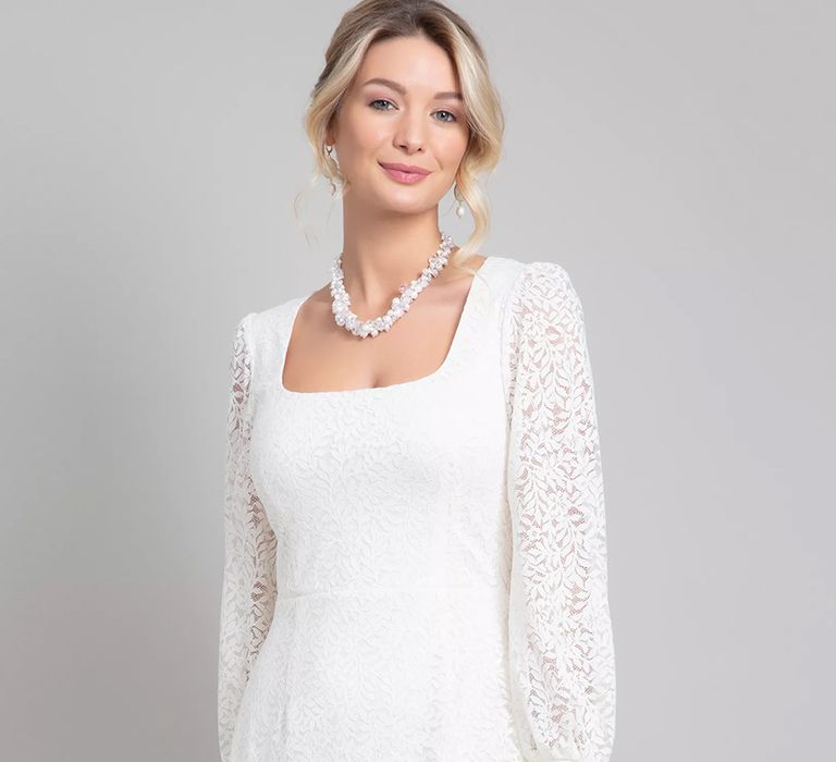 Front view of budget friendly short lace wedding dress with square neckline and full length sleeves from Alie Street