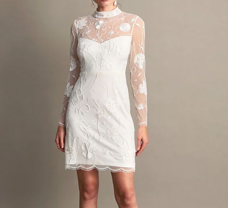 Front view of embroidered short budget friendly wedding dress with mesh sleeves from Monsoon