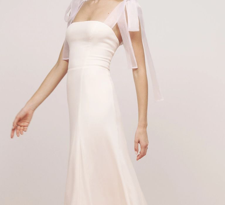 Front view of budget wedding dress with back smocking, tie straps, square neckline from Reformation