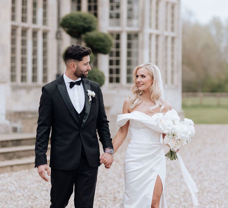 bride-carrying-white-rose-bouquet-in-off-the-shoulder