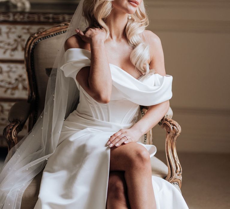 bride-in-boned-bodice-off-the-shoulder-wedding-dress-with-blonde-hollywood-waves