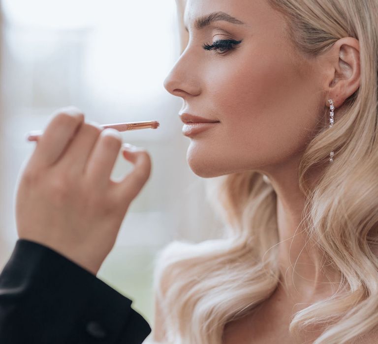 bride-with-smoky-eye-makeup-gets-her-lipstick-put-on