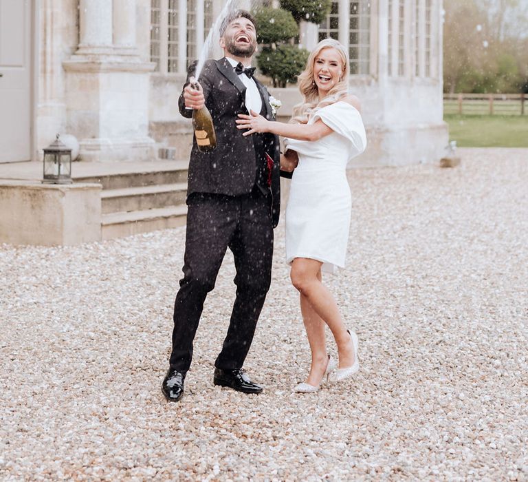 champagne-spray-for-bride-and-groom-at-howsham-hall