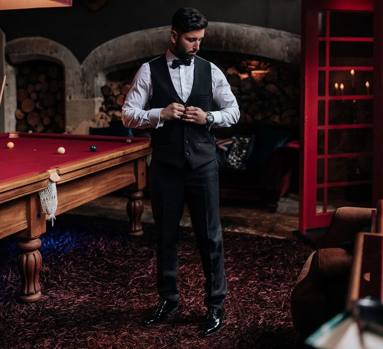 groom-in-black-tuxedo-getting-ready-for-wedding