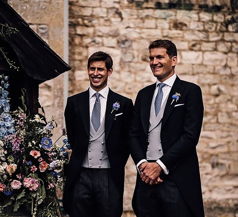 groom and best man wearing matching wedding suits 