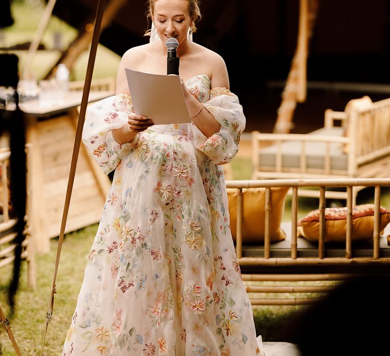 bride-in-flower-dress-reading-wedding-speech