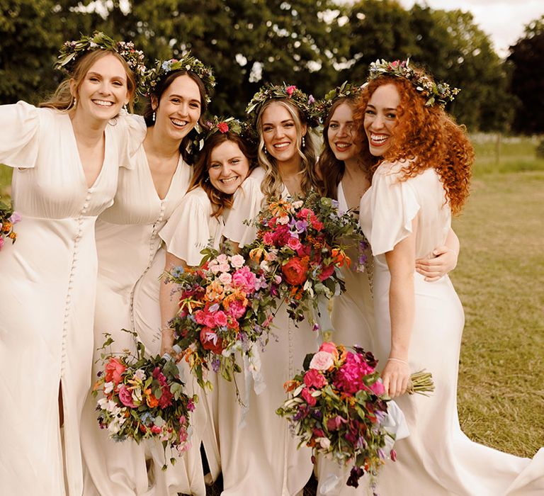 bridesmaids-in-ivory-bridesmaid-dresses-with-colourful-bouquets