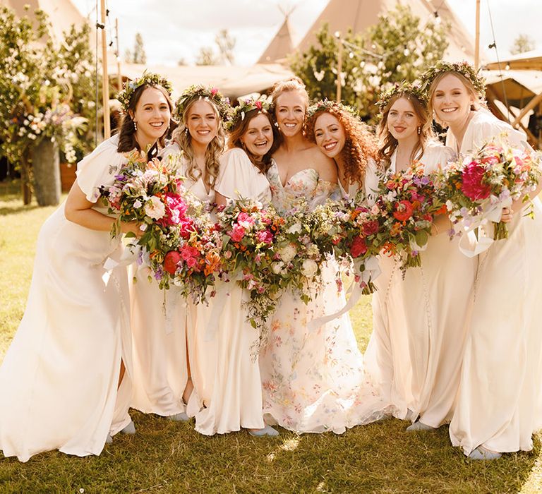 bridesmaids-wearing-ivory-bridesmaid-dresses-with-flower-crowns-and-bouquets