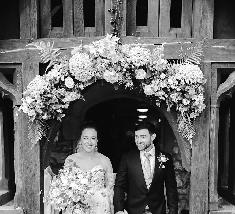 church-wedding-entrance-flowers-with-bride-and-groom